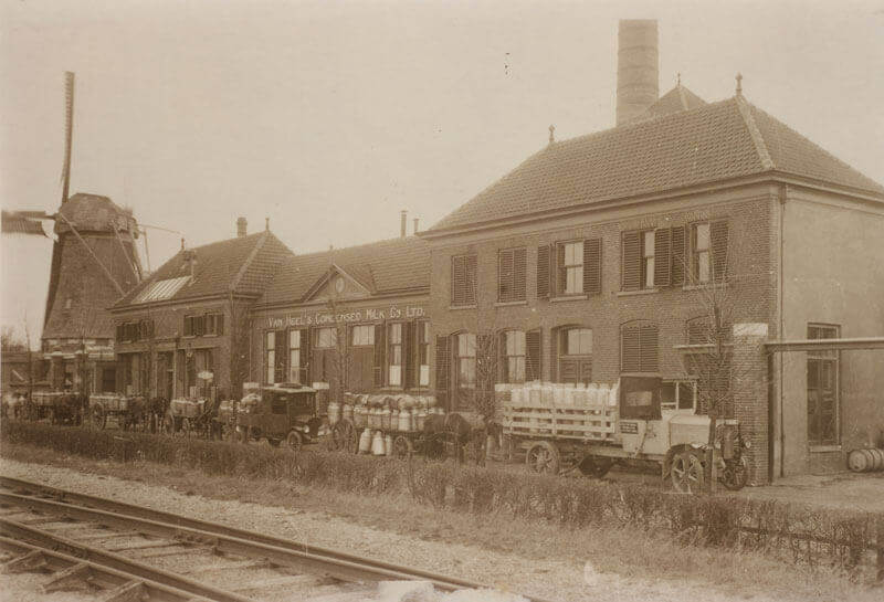 Van Heel factory in Kampen with a mill and truck filled with milk canisters next to it