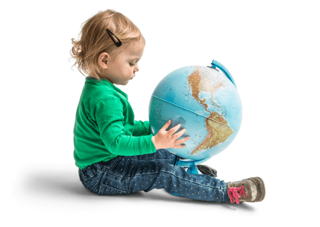 Little girl sitting on the ground with globe in her hands